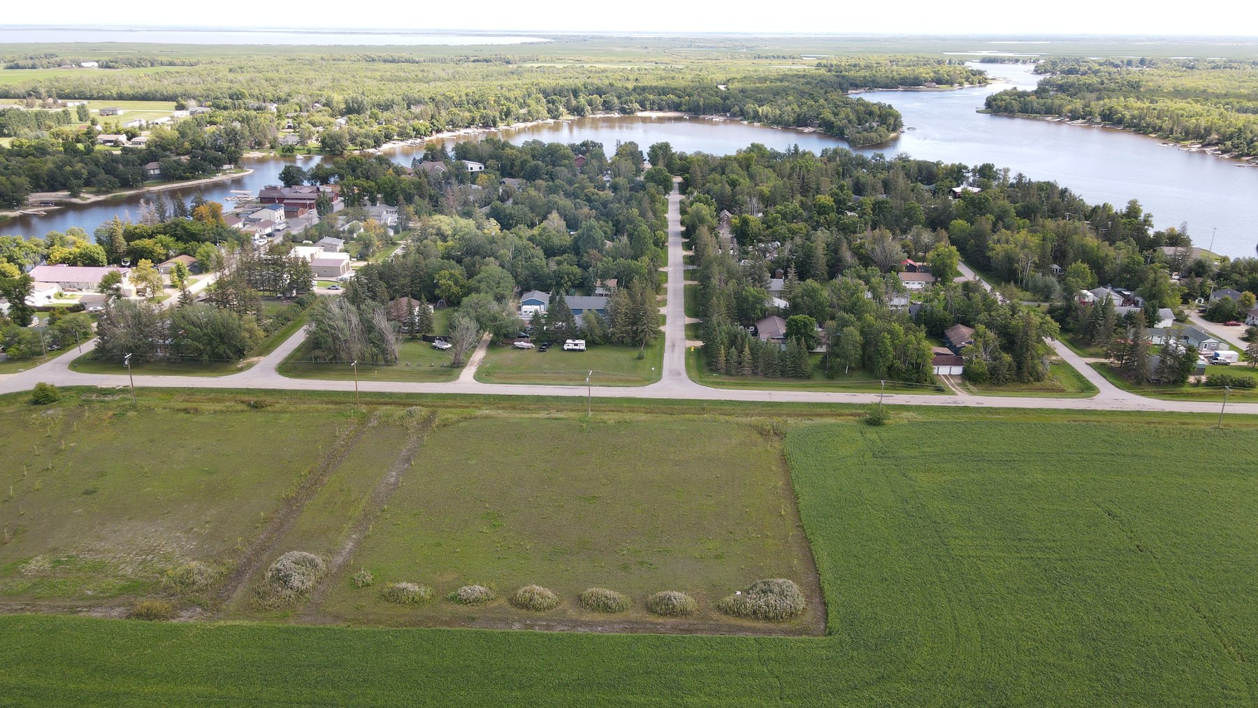 Netley Creek running past the village, with the open Palmer Road land in the foreground